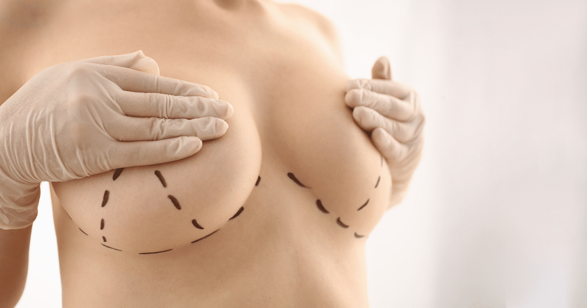 a woman cover her breasts with her hands